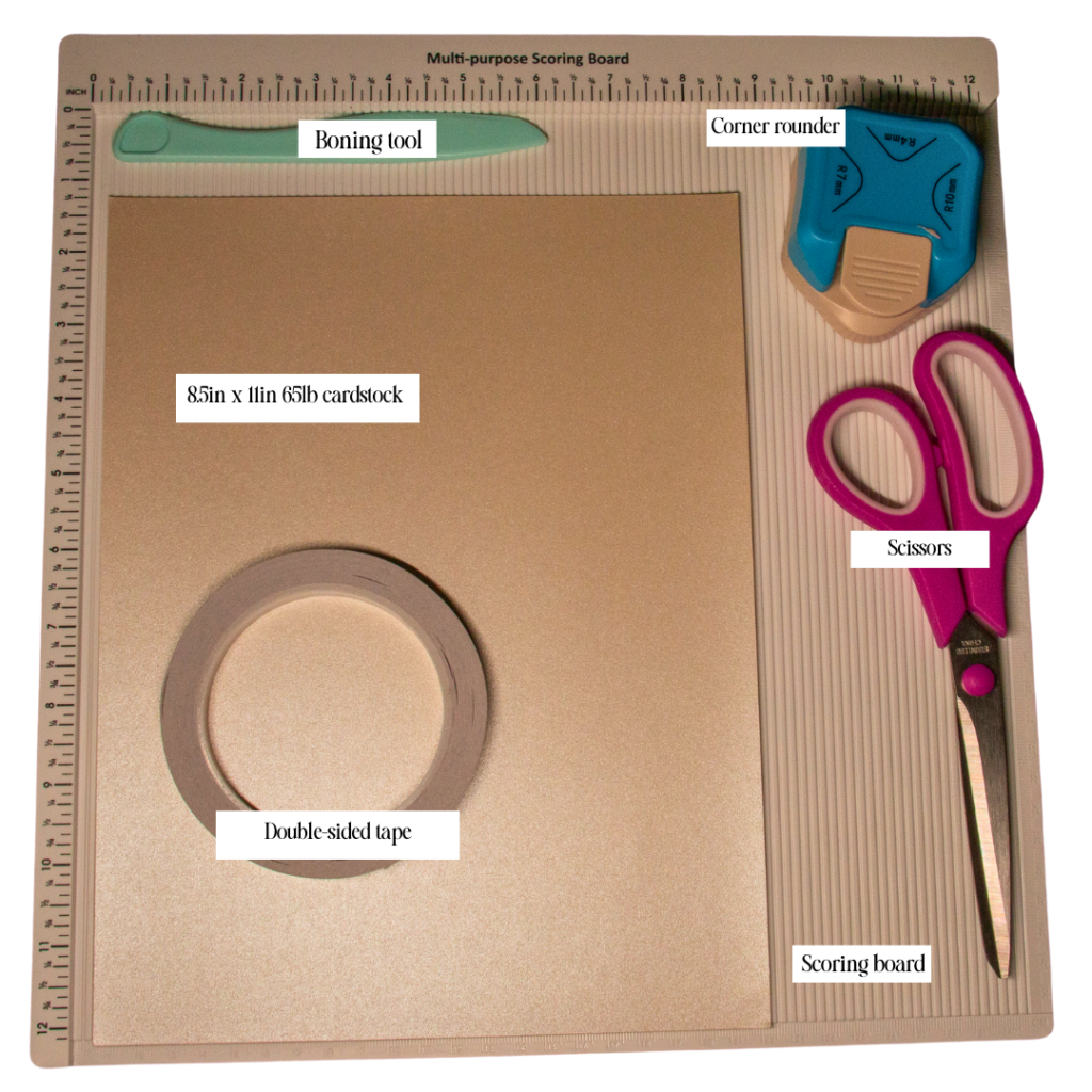 Materials for project: Boning tool; double-sided tape; 8.5in x 11in 65lb cardstock; scissors; corner rounder; scoring board