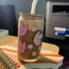 Pink butterflies and flower 16oz glass cup with coffee in it