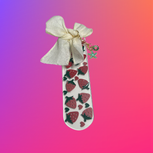 Strawberry bookmark with an ivory ribbon and charms.