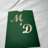 Green pocket envelope with initials