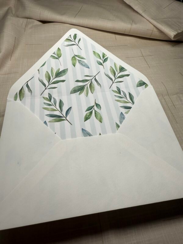 an A7 white envelope with green leaves on it