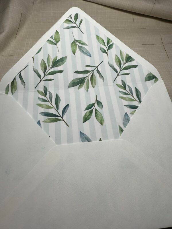 an A7 white envelope with green leaves on it